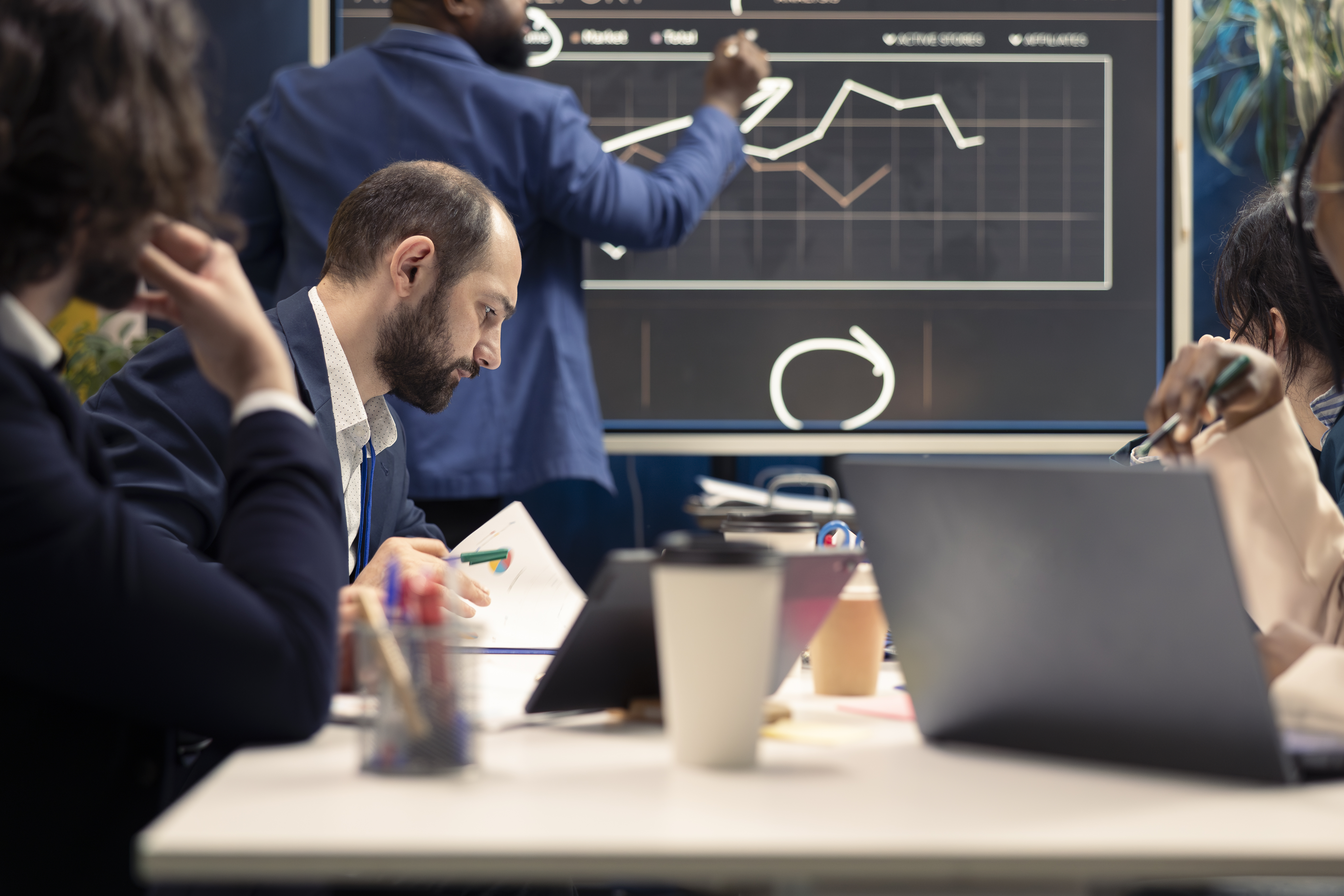 Corporate employees examining organizational progress during a meeting